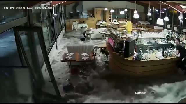 Wave Crashes Through Windows of Italian Restaurant
